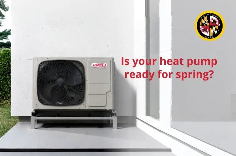 Technician inspecting an outdoor heat pump unit showing signs of ice buildup in late winter